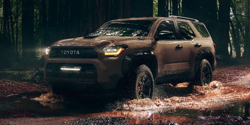 2025 Toyota 4Runner off-roading through muddy terrain near Van Nuys, CA, showcasing rugged design and advanced 4x4 capability.