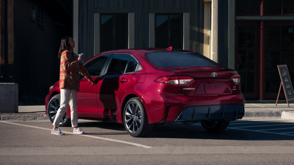 Driver standing next to the 2026 Toyota Corolla