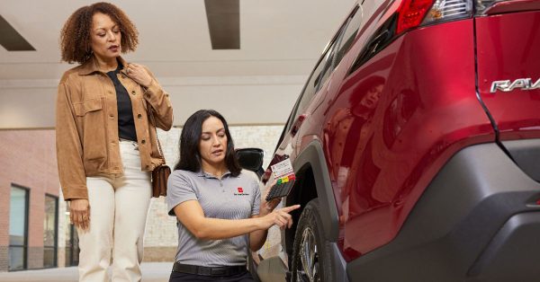 Customer speaking with salesperson at a Toyota dealership