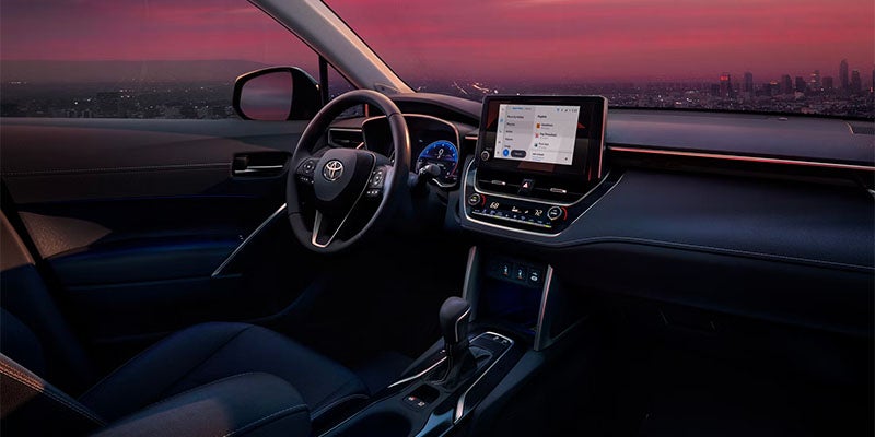 Interior view of the Toyota Corolla Cross dashboard and steering wheel with touchscreen display