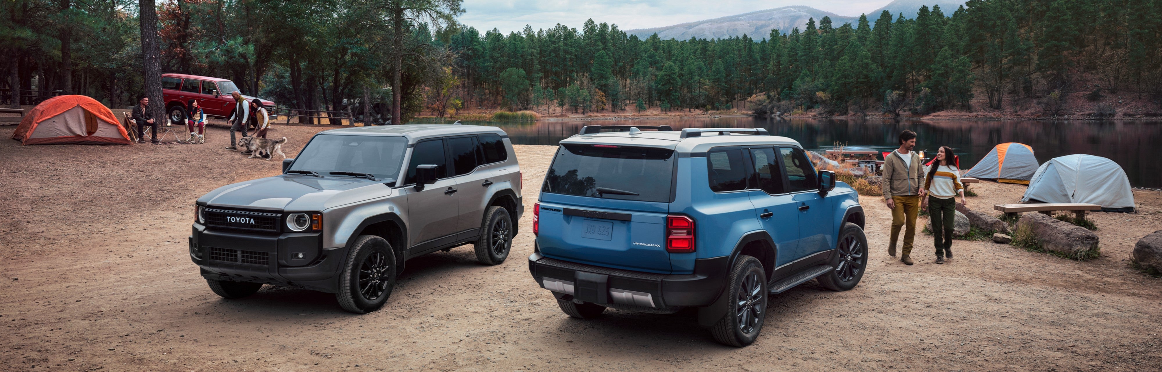 Two 2027 Toyota Land Cruisers near a body of water