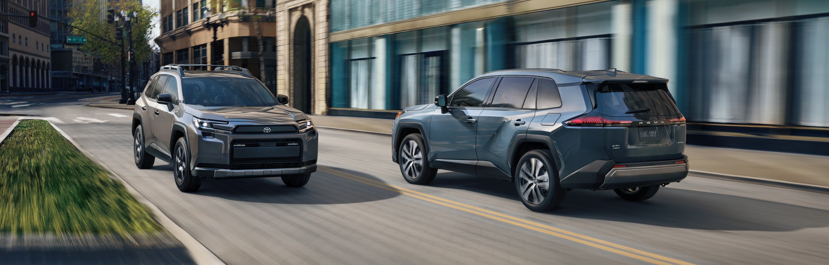 Two 2026 Toyota RAV4 models being driven along opposite sides of the road