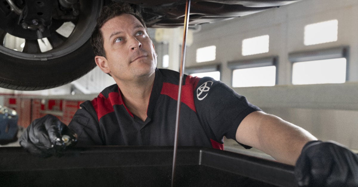 Toyota service technician working on a vehicle