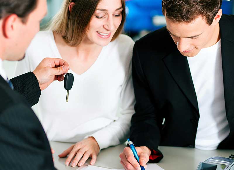 couple getting keys from salesman Keyes Toyota in Van Nuys CA